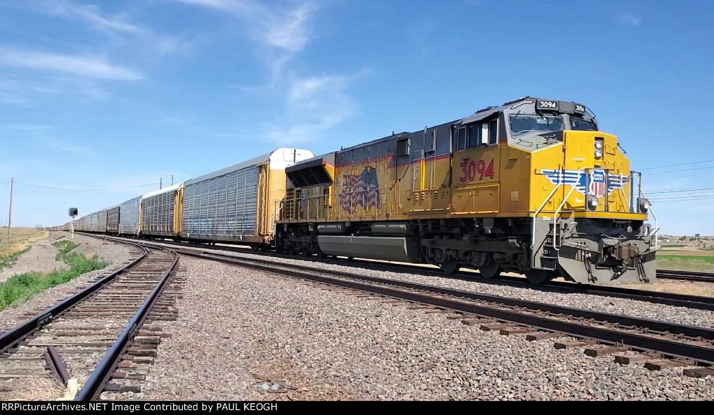 UP 3094 Rear DPU Pushing A Autorack Train Rolls By Me on the west end of Kimball, Nebraska heading westbound. 